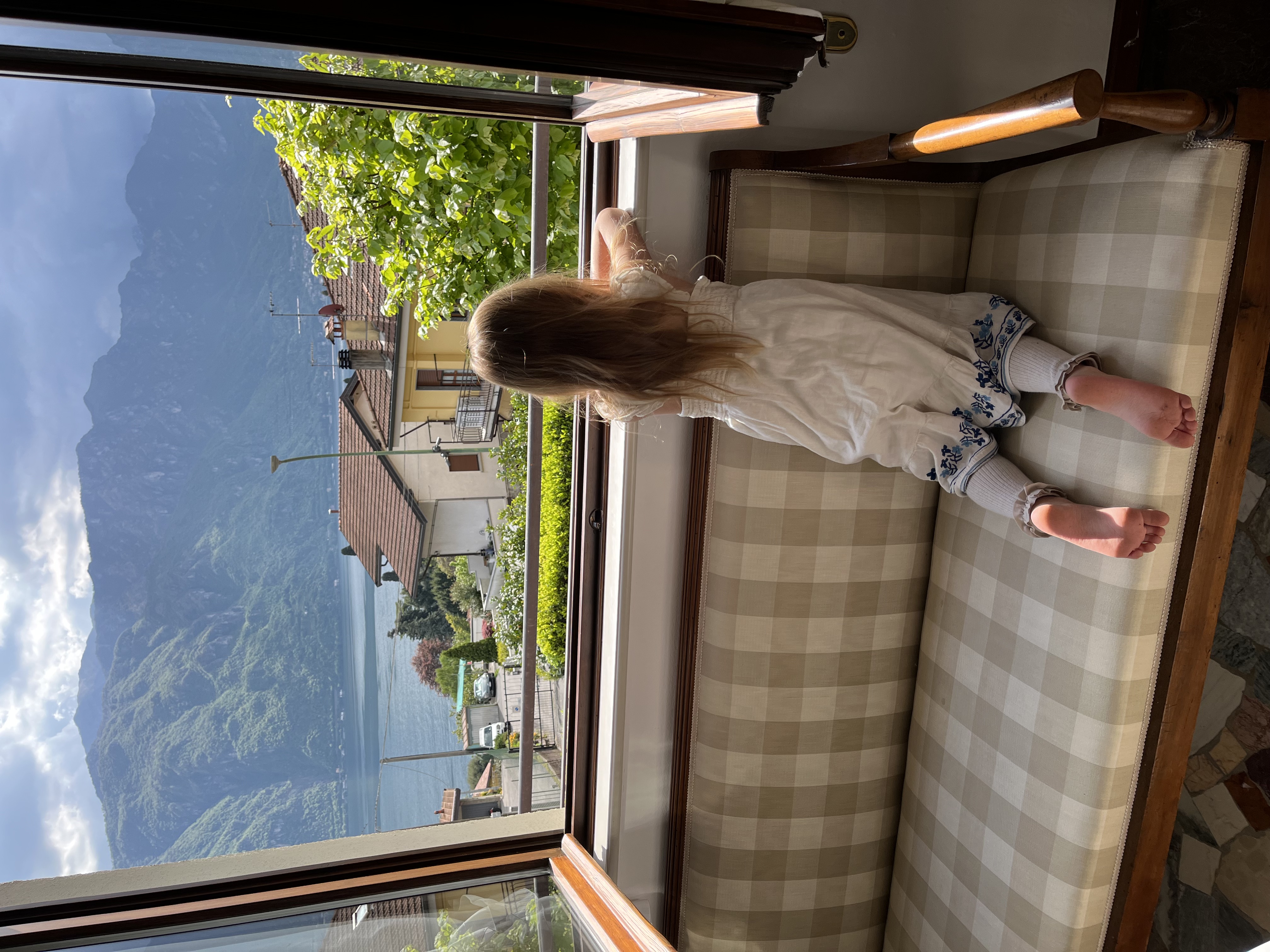 A young girl looking out over Lake Como and the mountains in Italy.