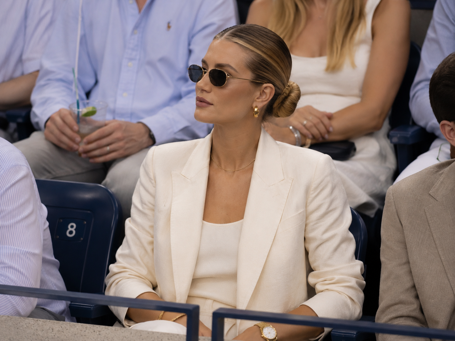 Cream tailoring worn courtside at a tennis event.